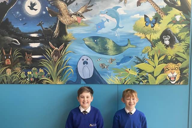 Archie and Chase with the nightjar mural at Hatfield Woodhouse Primary School.