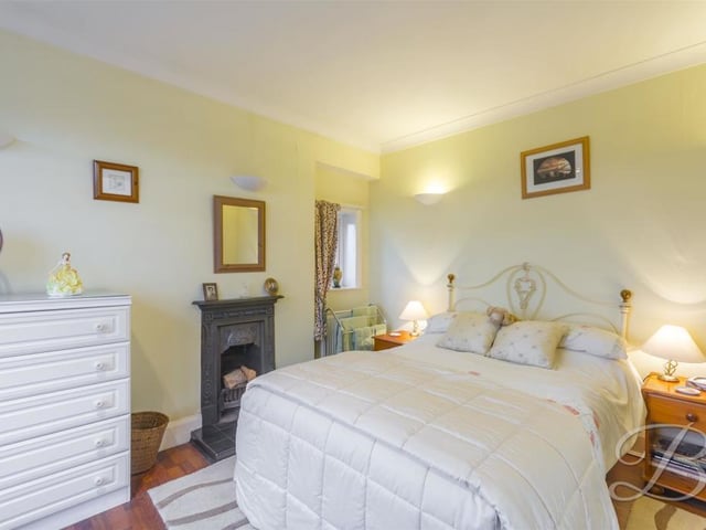 The third bedroom is full of character and even has its own feature fireplace. It also boasts a carpeted floor, central heating radiator and dual aspect windows.