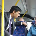 Rishi Sunak speaks with a bus passenger.