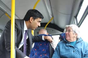 Rishi Sunak speaks with a bus passenger.