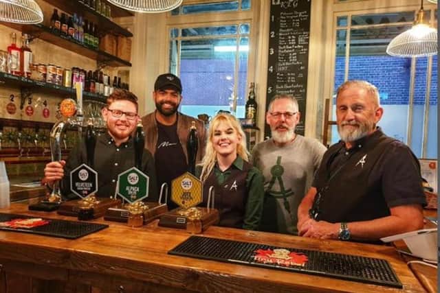 Luke Thompson and other staff members in the pub before Covid-19.