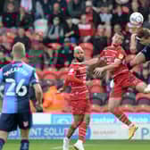 Tommy Rowe challenges Wycombe's David Wheeler in the air. Picture: Howard Roe/AHPIX