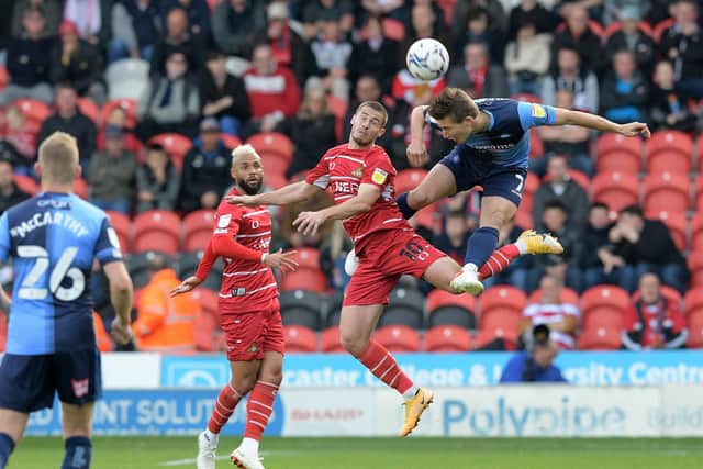 Tommy Rowe challenges Wycombe's David Wheeler in the air. Picture: Howard Roe/AHPIX