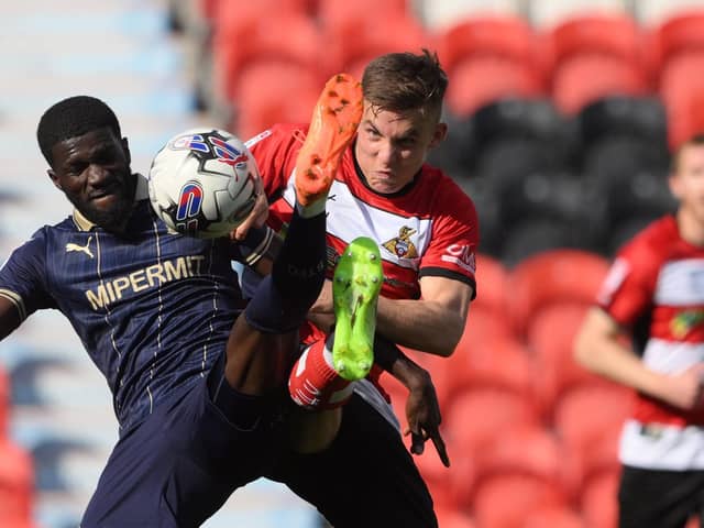George Broadbent battles for the ball.