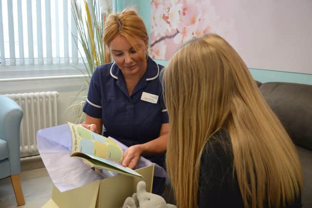 Colleen Biltcliffe, Doncaster and Bassetlaw Teaching Hospital Midwife for Safeguarding, showing a patient the HOPE box contents