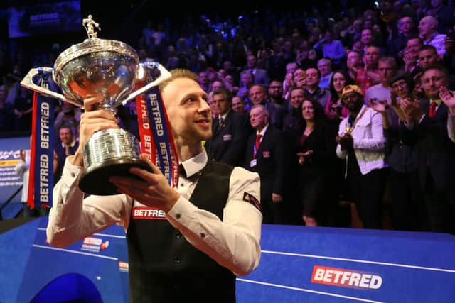 Judd Trump celebrates with the trophy after winning the 2019 Betfred World Championship at The Crucible, Sheffield. Photo: Richard Sellers/PA Wire