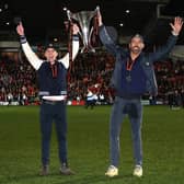 Rob McElhenney and Ryan Reynolds, owners of Wrexham celebrate with the Vanarama National League trophy as Wrexham win the Vanarama National League and are promoted to the English Football League. (Photo by Jan Kruger/Getty Images)