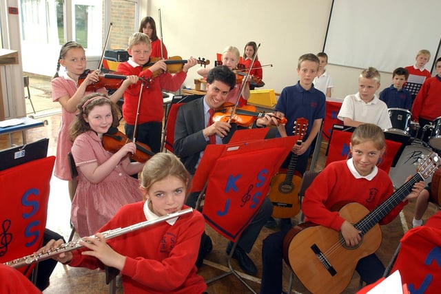 Doncaster North MP Ed Miliband, who used to play violin, picked up the bow again to pose with Kirk Sandall Junior School's orchestra back in 2005