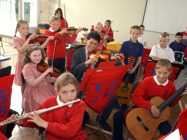 Doncaster North MP Ed Miliband, who used to play violin, picked up the bow again to pose with Kirk Sandall Junior School's orchestra back in 2005