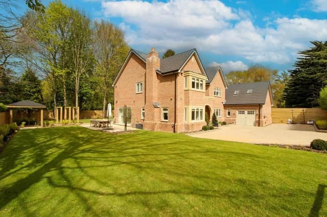 The detached home with six bedrooms and two-storey double garage with gym that's for sale.