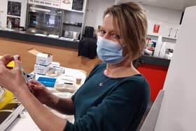 A doctor prepares a vaccine at the Keepmoat Stadium vaccination centre