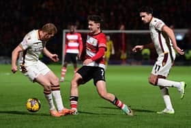 Luke Molyneux gets past Bradford's Brad Halliday Picture: Andrew Roe/AHPIX LTD