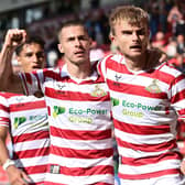Doncaster's George Miller celebrates his goal against Sutton United with Tommy Rowe.
