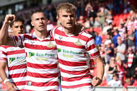 Doncaster's George Miller celebrates his goal against Sutton United with Tommy Rowe.