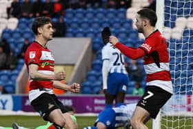 Harrison Biggins celebrates his goal with Luke Molyneux.