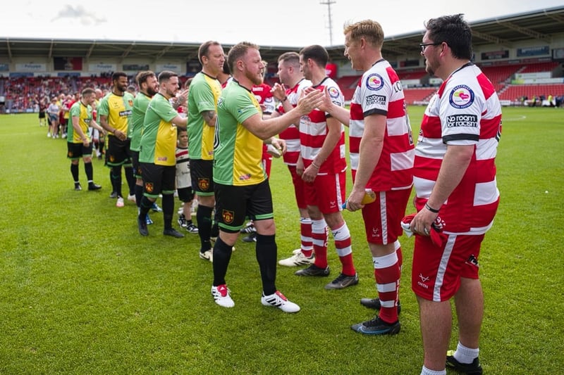 Players swap handshakes ahead of the game.
