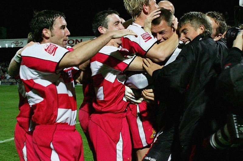 Jan Budtz (2nd R) of Doncaster is mobbed by players after his side's penalty shoot-out victory against Manchester City in the Carling Cup Round Two match on September 21, 2005.