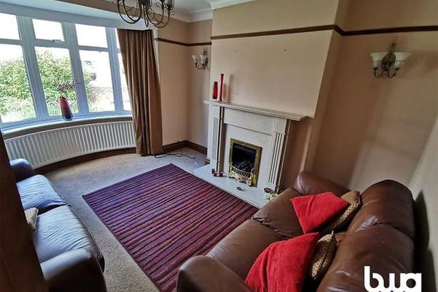 Located at the front of the property, this lounge space features an electric fire and light fittings on the wall. The property was sold for £93,950 back in 2002 but is now available for auction.