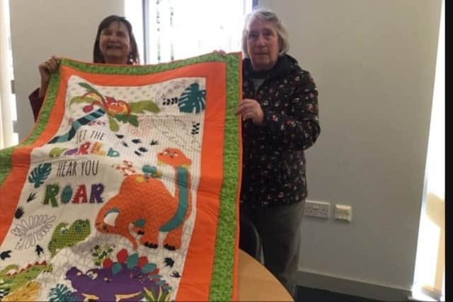 Members of Thorne Quilters donating 12 quilts to Project Linus Doncaster branch.