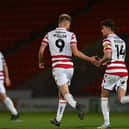 George Miller celebrates a goal with Harrison Biggins.