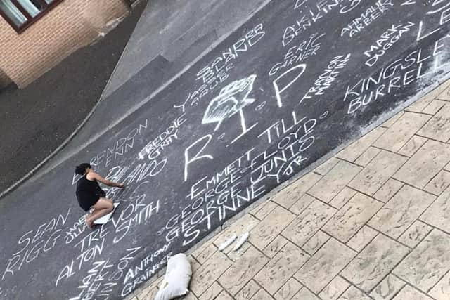 Evie writing names on the mural.