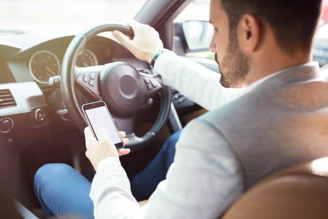 Hundred drivers caught using mobile phone behind the wheel.