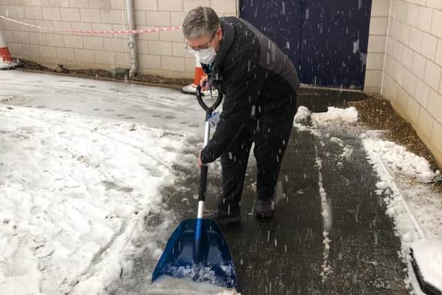 Andrew Russell clearing snow at the Dearne Valley Leisure centre vaccination centre