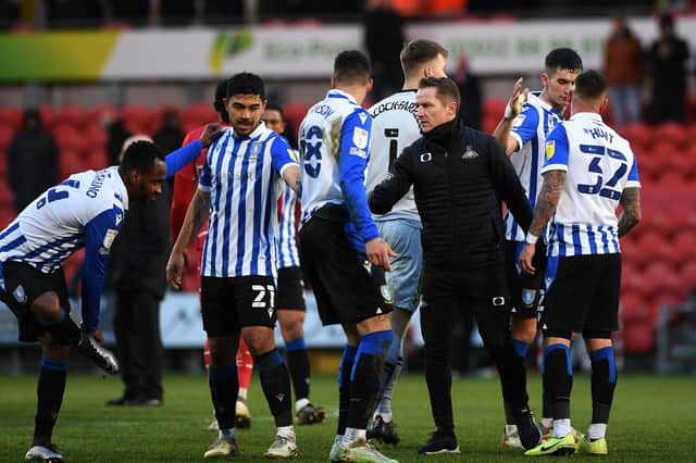 Gary McSheffrey congratulates Sheffield Wednesday's players after their 3-1 win at the Eco-Power Stadium on Saturday.