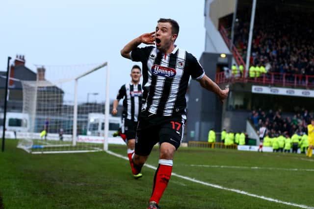 Ross Hannah celebrates scoring against Huddersfield Town in the FA Cup third round during his Grimsby Town days (photo by Matthew Lewis/Getty Images).