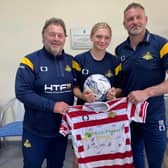 Belles ace Abi Coley (centre) pictured with the club's CEO Russ Green (left) and manager Nick Buxton.