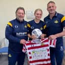Belles ace Abi Coley (centre) pictured with the club's CEO Russ Green (left) and manager Nick Buxton.