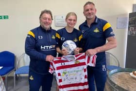 Belles ace Abi Coley (centre) pictured with the club's CEO Russ Green (left) and manager Nick Buxton.