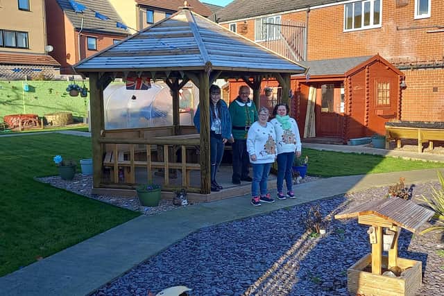 Community Connect service users enjoying their new garden pagoda (back, from left) Lydia Seekings, Reuben Taylor, (front) Rebecca Lilley and Jordan Bell