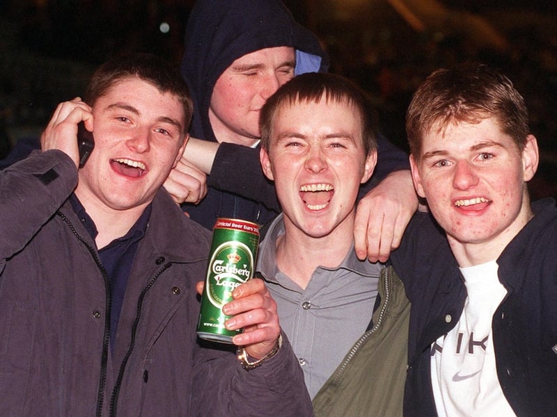 A drink in one hand and phoning to wish people Happy New Year with the other