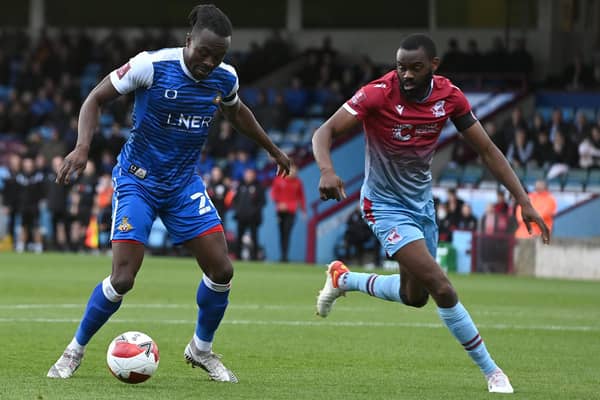 Joe Dodoo fends off Scunthorpe's Emmanuel Onariase. Picture: Andrew Roe/AHPIX