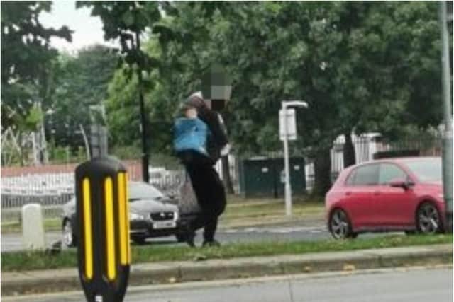 The man was spotted carrying the woman over his shoulder in Holmes Market.