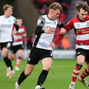 Doncaster's Kyle Hurst battles with Morecambe's JJ McKiernan for the ball. (Picture:Andrew Roe/AHPIX LTD)