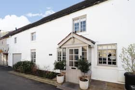 The attractive frontage of the historic cottage that is for sale in the village of Burghwallis.