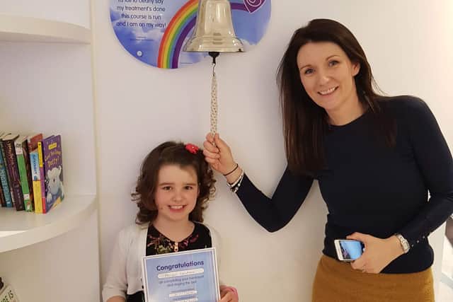 Abigail and mum Jo ringing the bell on the Cancer Ward at Sheffield Children's