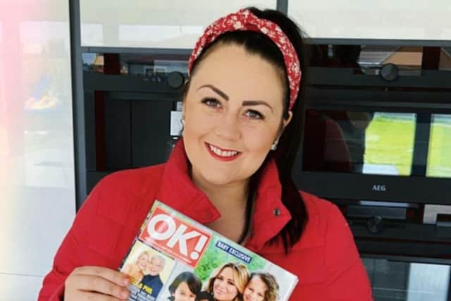Lisa Hensby of LH Interior Design with a copy of the OK! Magazine her work is featured in