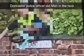The clip appears to show a black man being repeatedly struck in the face by a police officer.