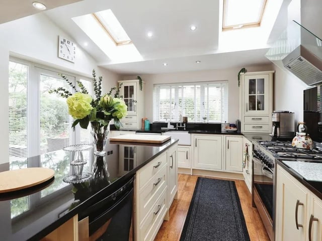 A stylish, modern kitchen links to dining and family areas.