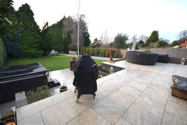 The large patio area with lawned garden.