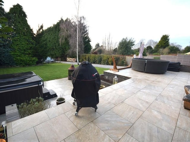 The large patio area with lawned garden.
