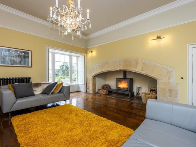 Another stunning room with a vast central fireplace as a main feature.