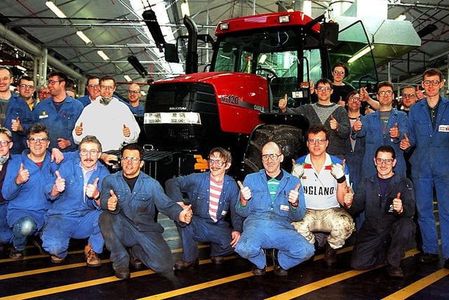 Case workers celebrate their company's announcement of a huge investment programme in Doncaster in May 1997. The tractor in the picture is a Maxxam 120 horsepower vehicle.