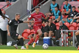 Tommy Rowe battles with Morecambe's Shane McLoughlin. Photo: Howard Roe/AHPIX LTD