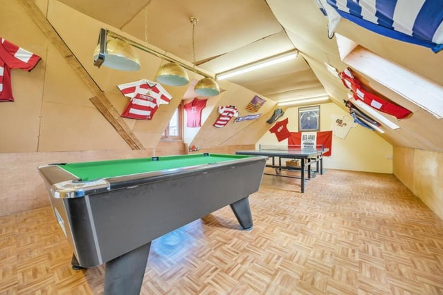 Versatile space above the garage is currently used as a games room.