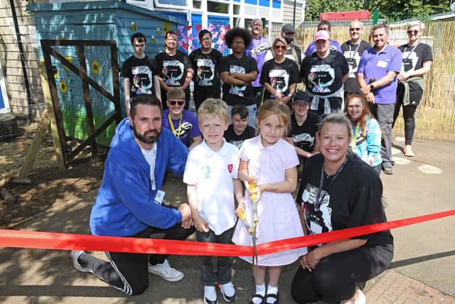 Head teacher Lee Bell with infants Niall Hamilton-Ellis,6 and Mia Nistor, 6 cutting the ribbon with Harrison College principal, Gemma Peebles