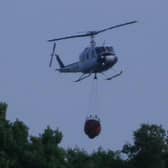 A specialist helicopter has been dropping lake water onto the flames.